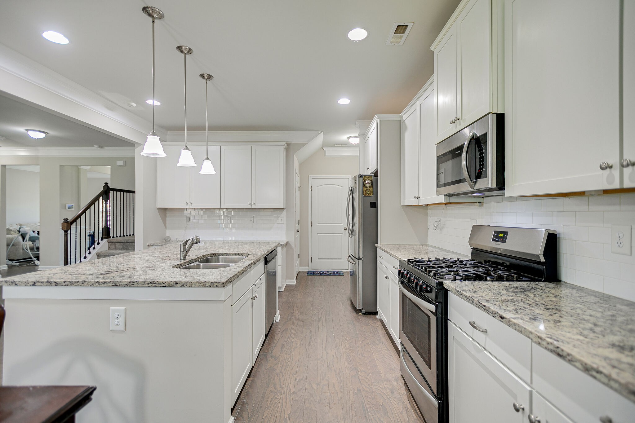 966 Carnation Drive Spring Hill, TN 37174 - Photo 16 of 31 a kitchen with stainless steel appliances granite countertop a sink stove and refrigerator