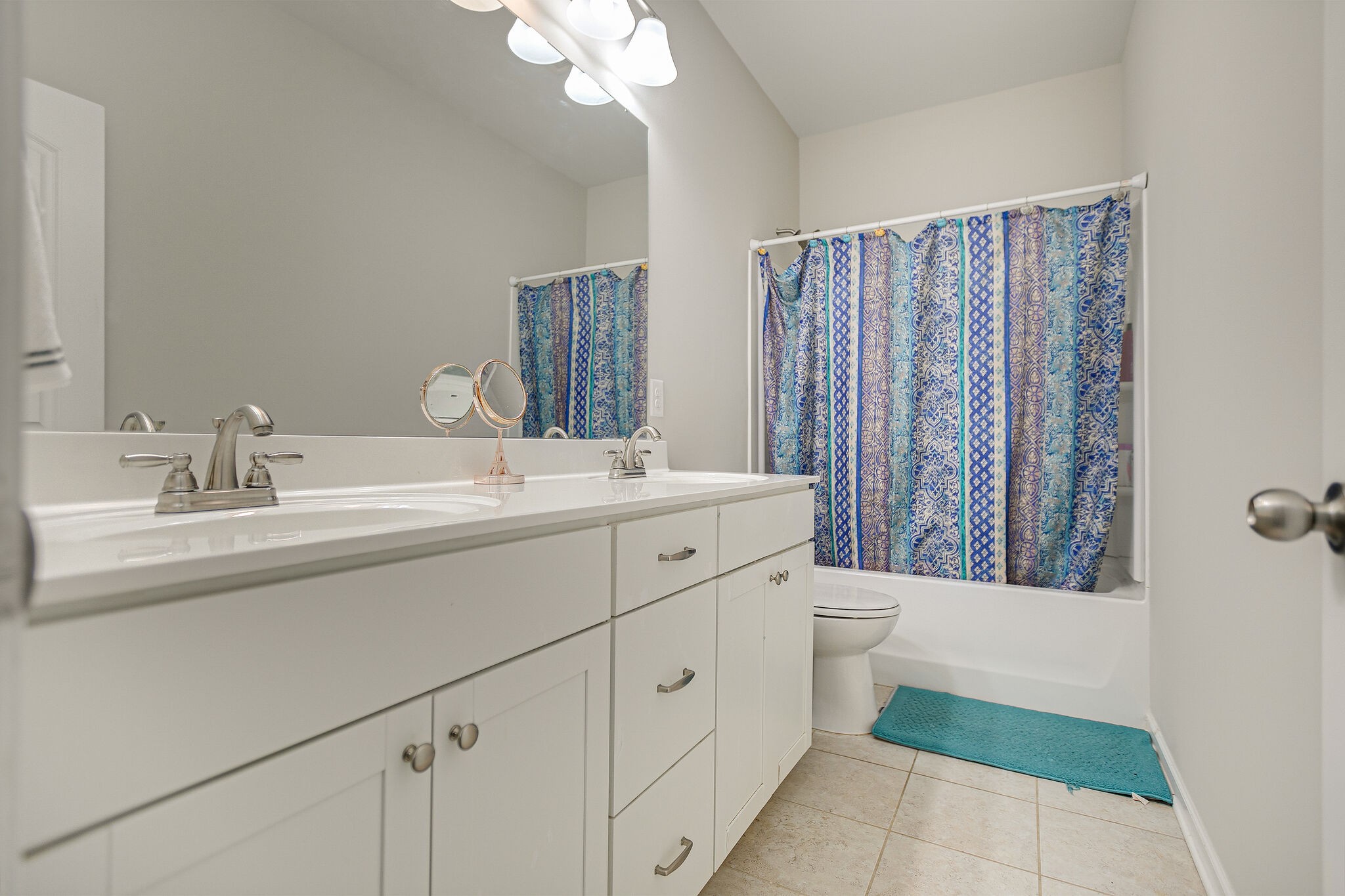 966 Carnation Drive Spring Hill, TN 37174 - Photo 25 of 31 a bathroom with a double vanity sink a mirror and a bathtub