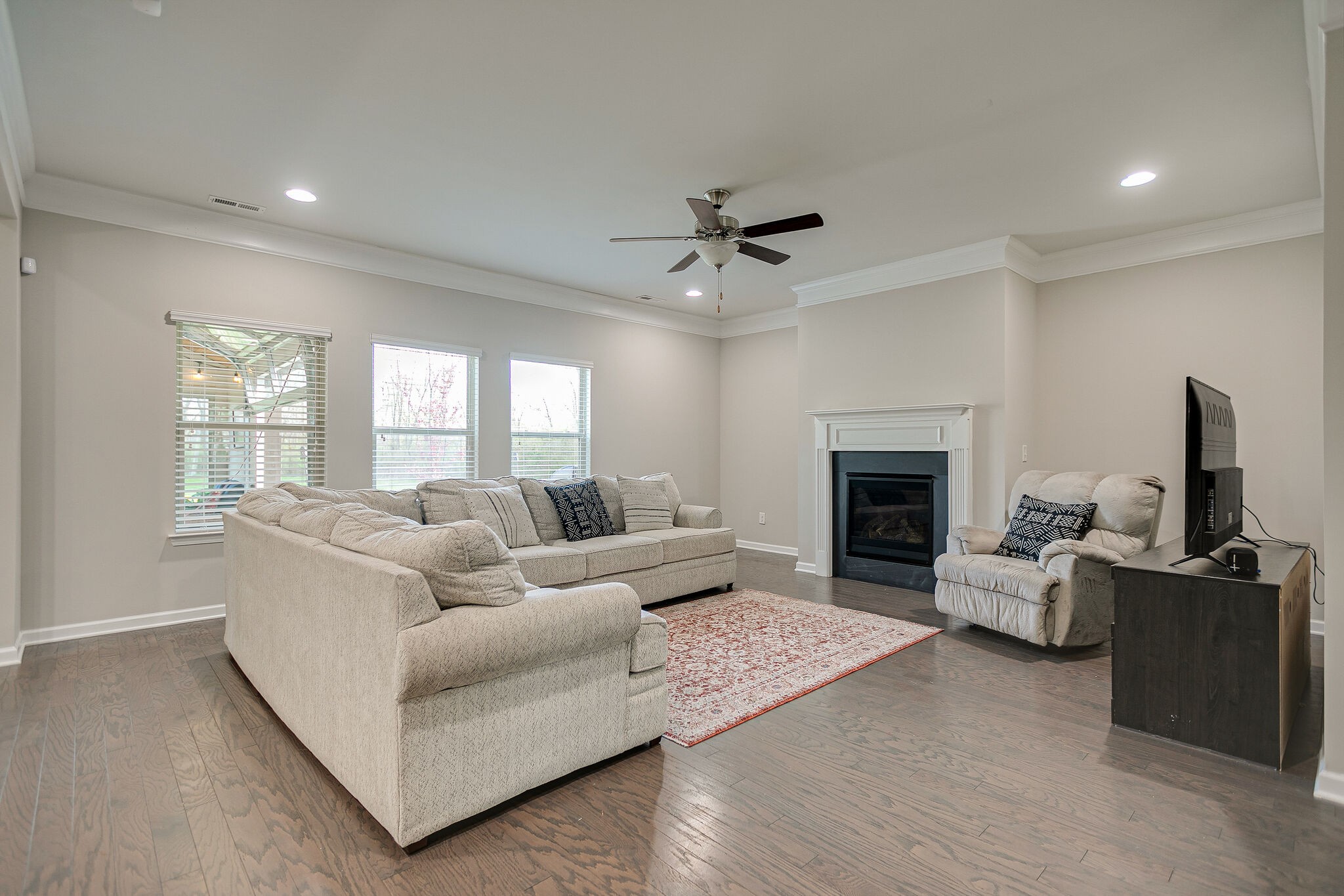 966 Carnation Drive Spring Hill, TN 37174 - Photo 8 of 31 a living room with furniture a fireplace and a flat screen tv