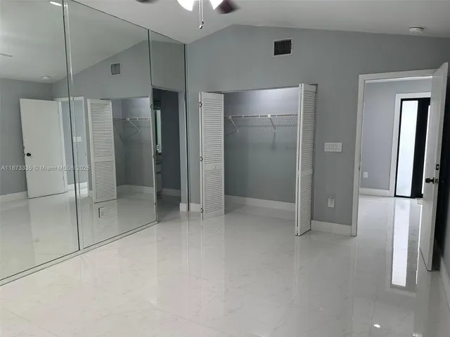 a bathroom with a shower and a glass door