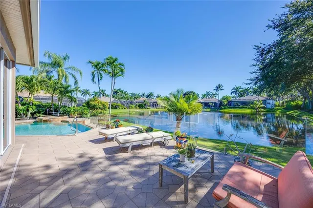 a view of swimming pool with outdoor seating and plants