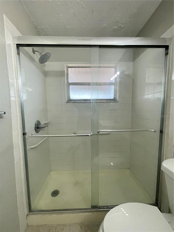 7986 Avenal Loop New Port Richey, FL 34655 - Photo 12 of 23 a bathroom with a shower and a toilet