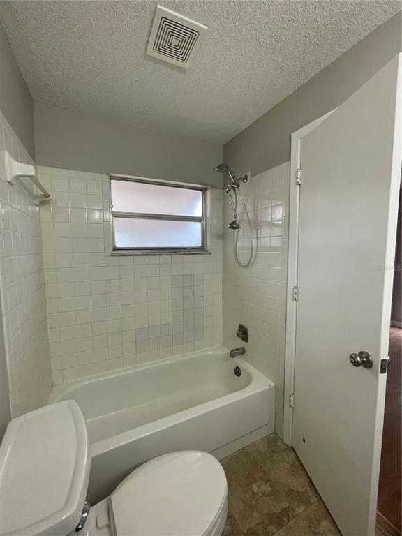 7986 Avenal Loop New Port Richey, FL 34655 - Photo 16 of 23 a bathroom with a toilet bathtub and shower