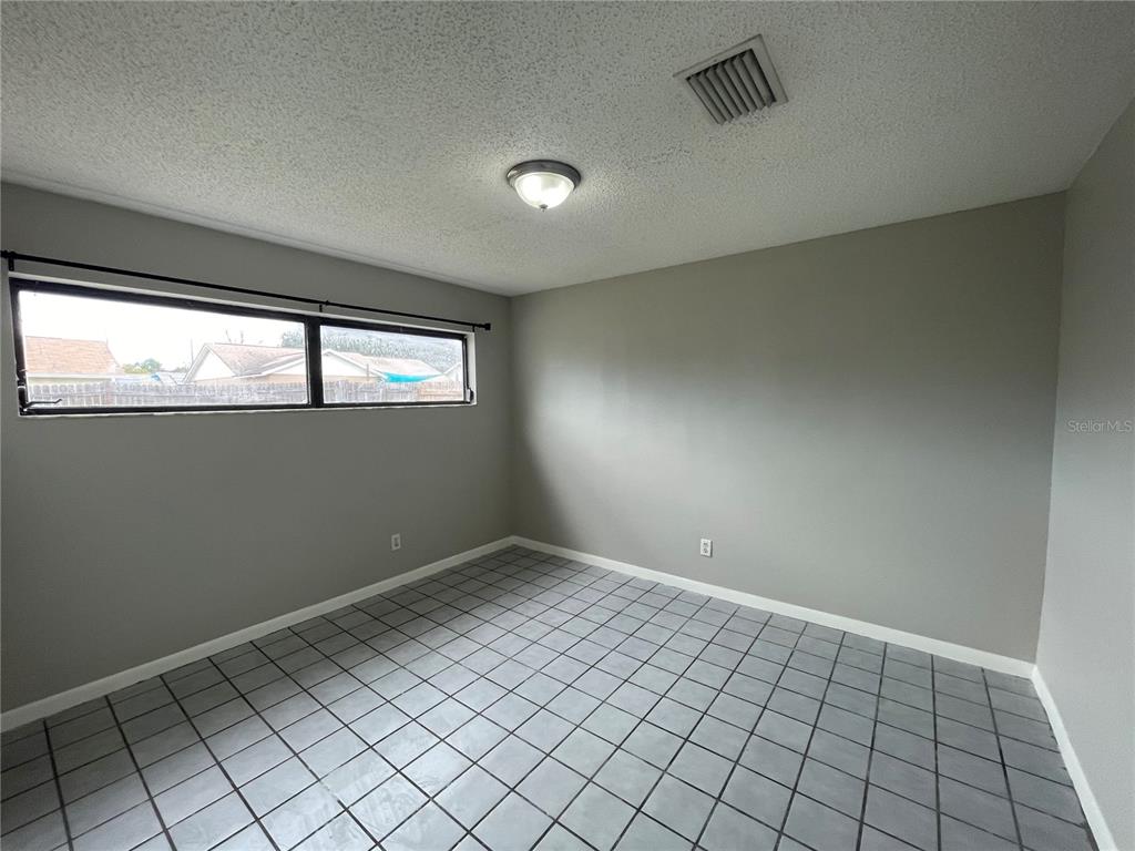 7986 Avenal Loop New Port Richey, FL 34655 - Photo 20 of 23 an empty room with windows
