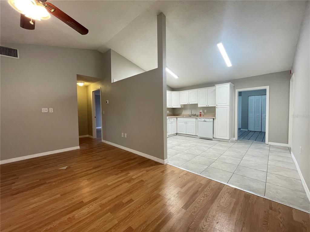 7986 Avenal Loop New Port Richey, FL 34655 - Photo 2 of 23 an empty room with wooden floor and windows