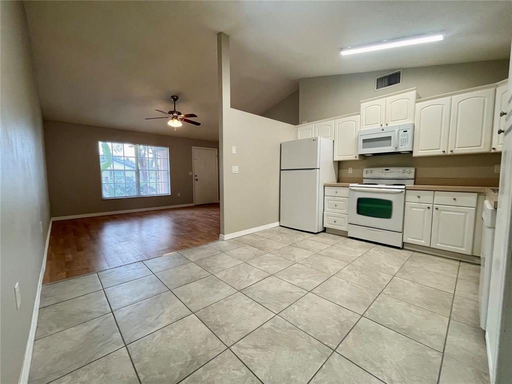 7986 Avenal Loop New Port Richey, FL 34655 - Photo 5 of 23 a kitchen with stainless steel appliances granite countertop a stove a sink and a refrigerator