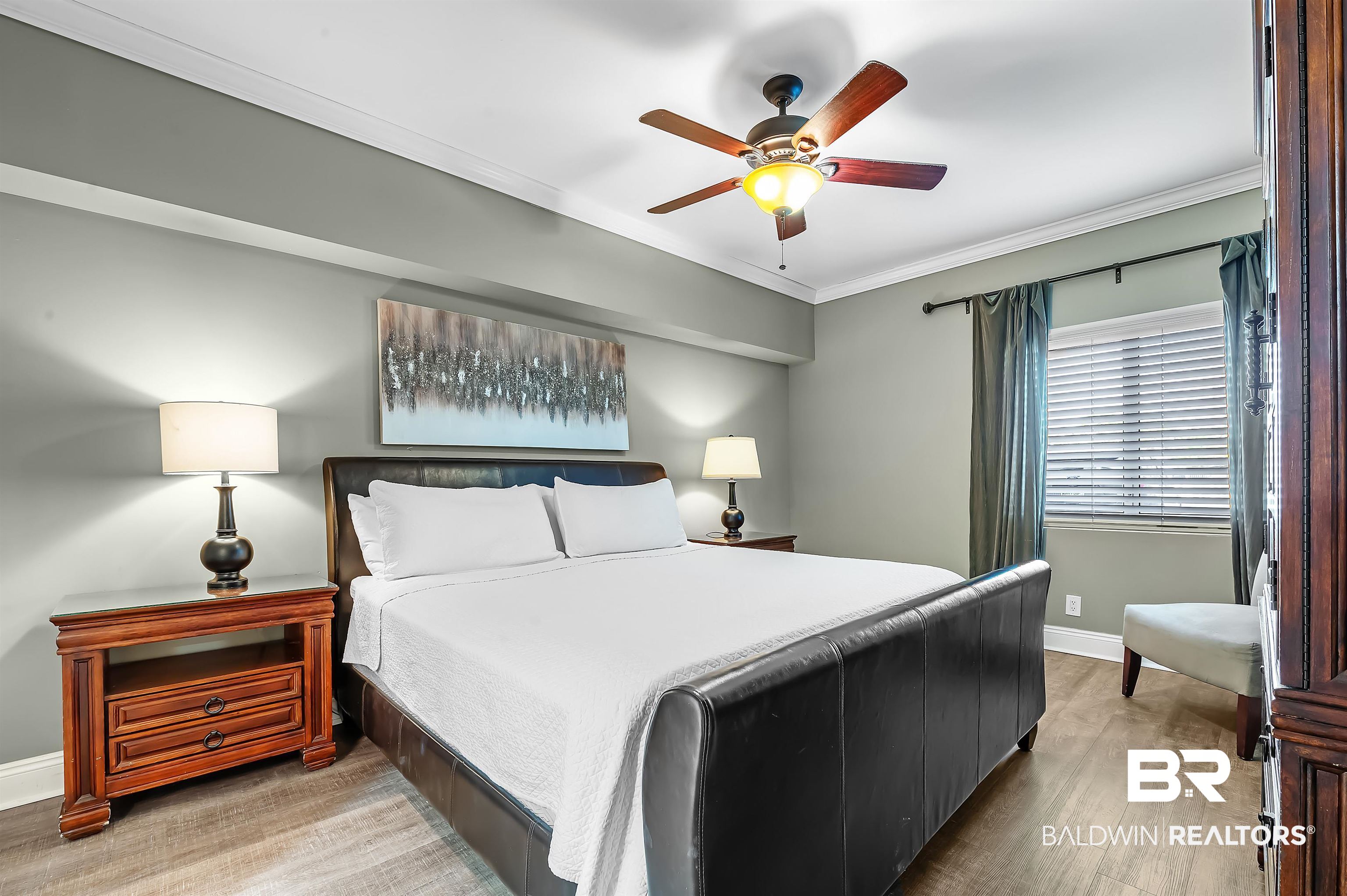 16287 Perdido Key Drive, Unit 105 Pensacola, FL 32507 - Photo 26 of 66 Bedroom featuring wood-finish flooring, a ceiling fan with integrated lighting, a window with blinds and drapes, and crown molding