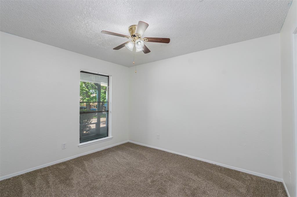 617 Rolling Ridge Court Azle, TX 76020 - Photo 7 of 20 Carpeted room featuring a ceiling fan with light fixture, a single window, and white baseboards