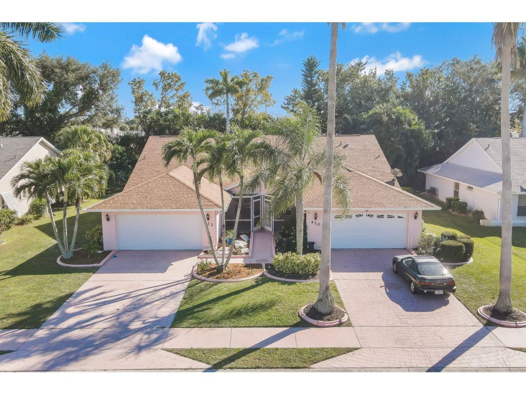 470 St Andrews Boulevard Naples, FL 34113 - Photo 2 of 32 a front view of a house with a yard