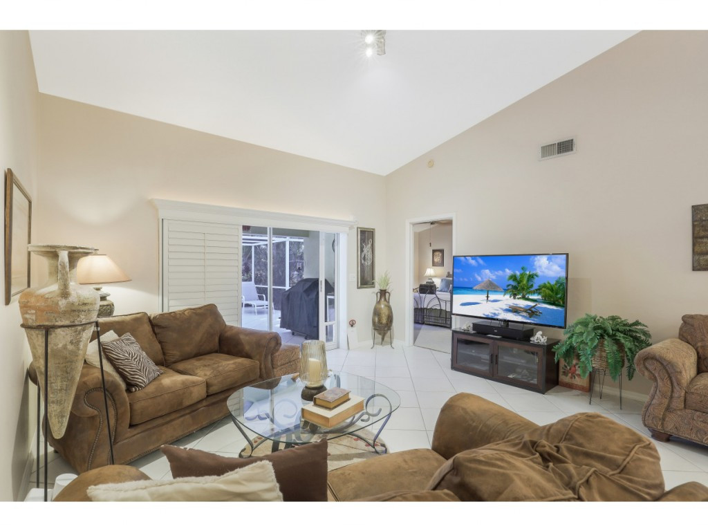 470 St Andrews Boulevard Naples, FL 34113 - Photo 11 of 32 a living room with furniture and a flat screen tv