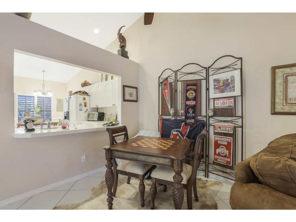 470 St Andrews Boulevard Naples, FL 34113 - Photo 12 of 32 a view of a dining room with furniture and window