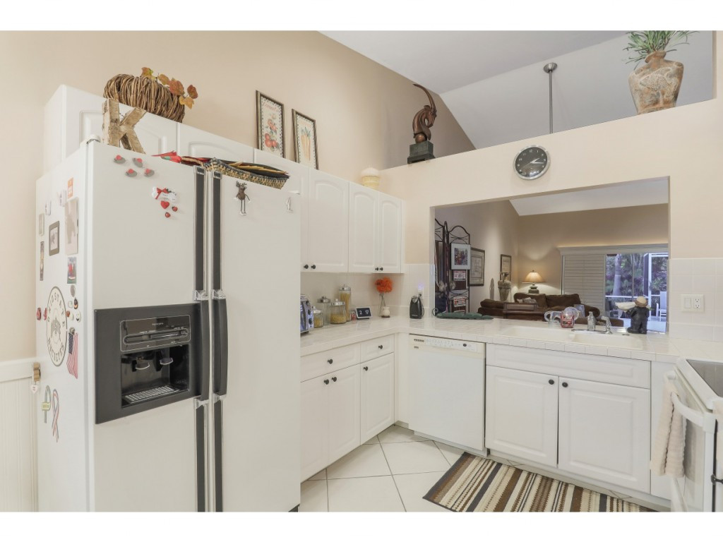470 St Andrews Boulevard Naples, FL 34113 - Photo 14 of 32 a kitchen with cabinets and window