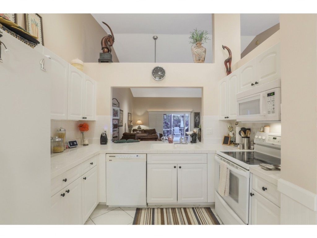 470 St Andrews Boulevard Naples, FL 34113 - Photo 15 of 32 a kitchen with a sink and cabinets