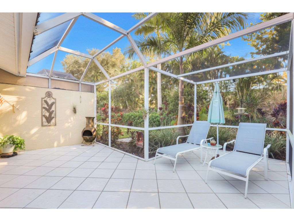 470 St Andrews Boulevard Naples, FL 34113 - Photo 17 of 32 a view of a patio with a table and chairs