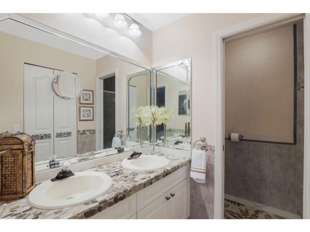 470 St Andrews Boulevard Naples, FL 34113 - Photo 21 of 32 a bathroom with a sink and a mirror