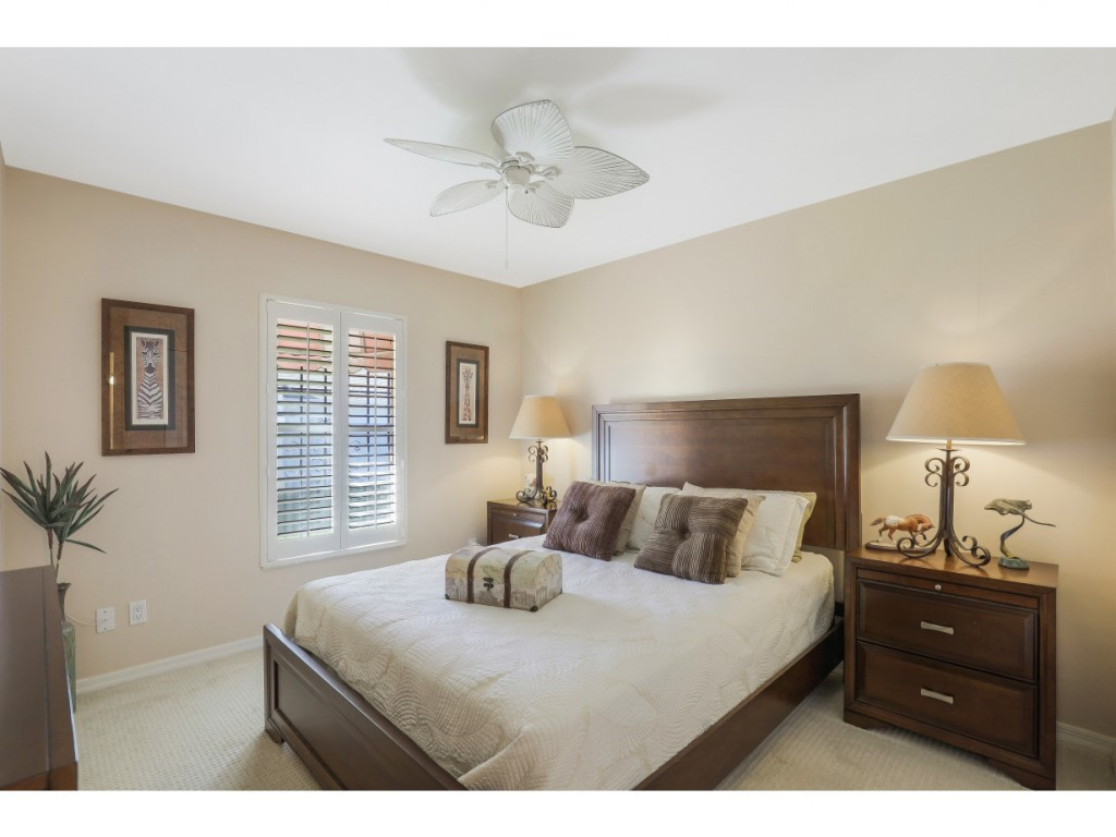 470 St Andrews Boulevard Naples, FL 34113 - Photo 22 of 32 a bedroom with a bed and a window