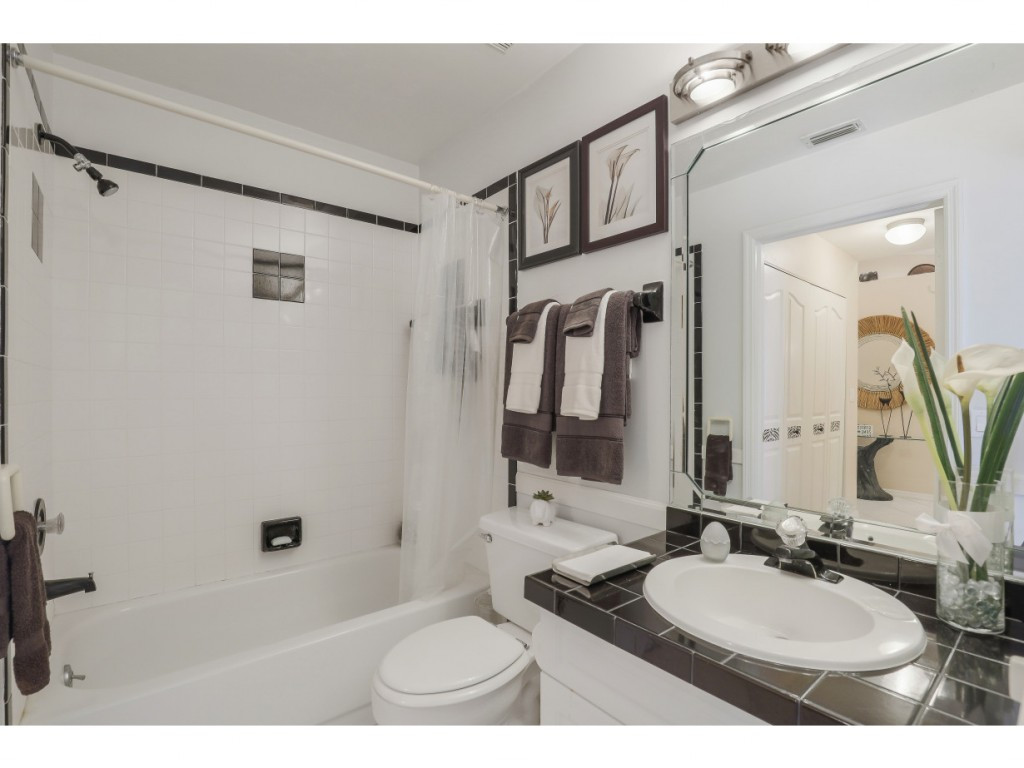 470 St Andrews Boulevard Naples, FL 34113 - Photo 23 of 32 a bathroom with a granite countertop sink mirror and a bathtub