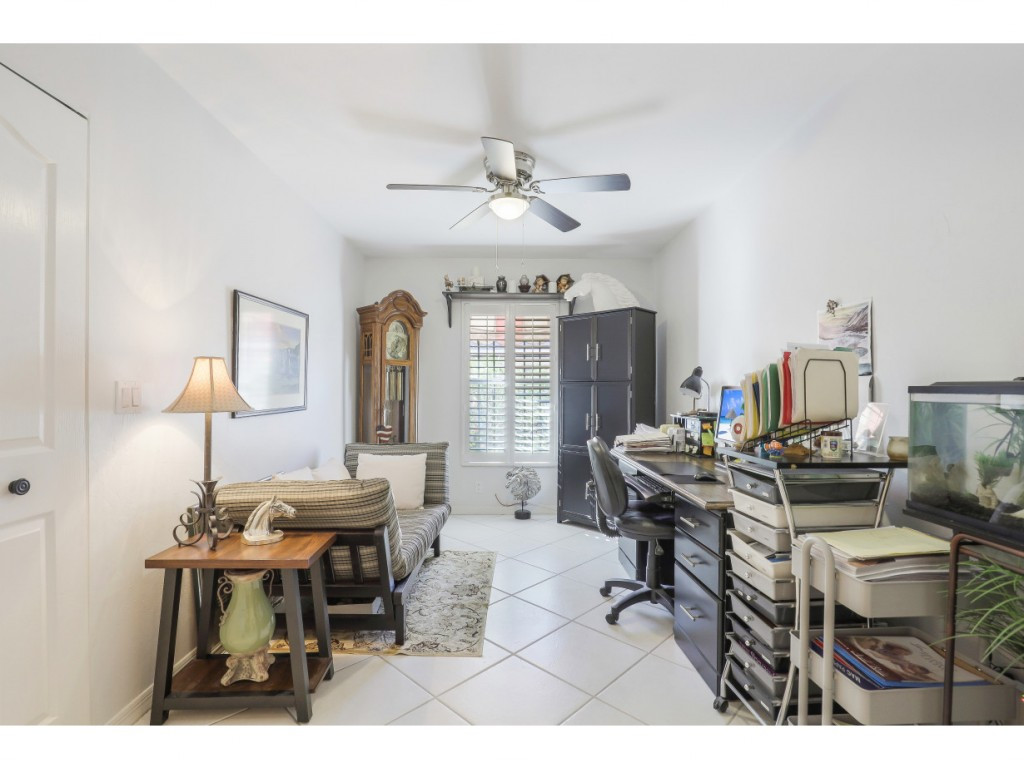 470 St Andrews Boulevard Naples, FL 34113 - Photo 24 of 32 a workspace with furniture and a chandelier