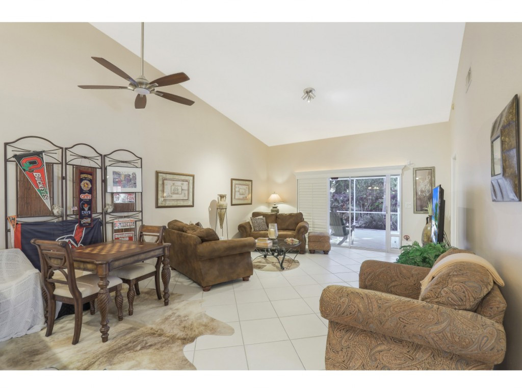 470 St Andrews Boulevard Naples, FL 34113 - Photo 9 of 32 a living room with furniture and a large window