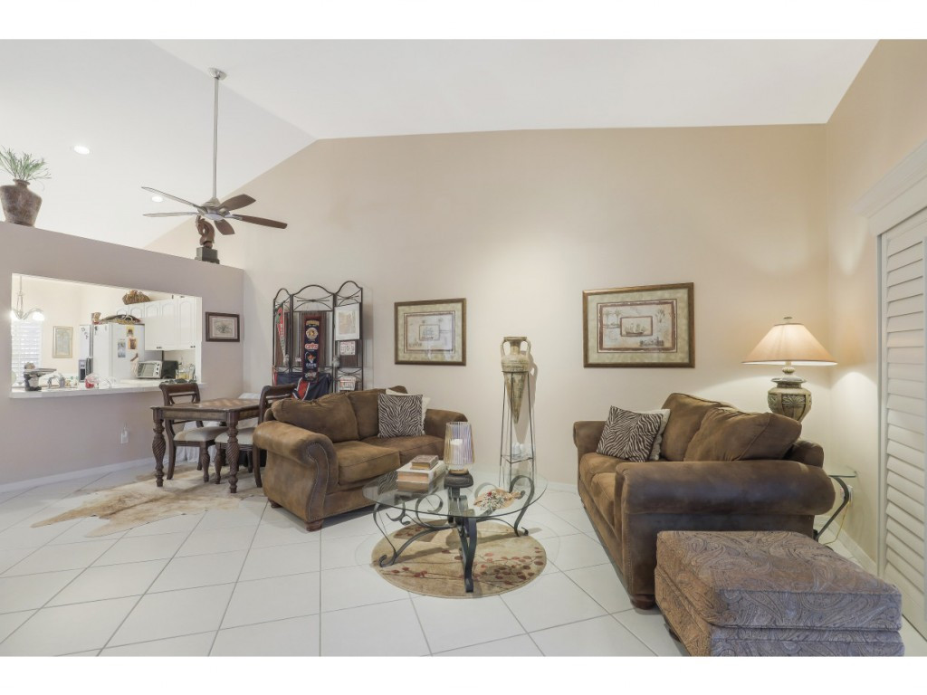 470 St Andrews Boulevard Naples, FL 34113 - Photo 10 of 32 a living room with furniture and a table