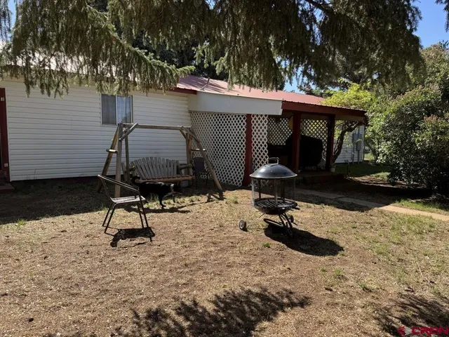 a view of a two chairs in a backyard