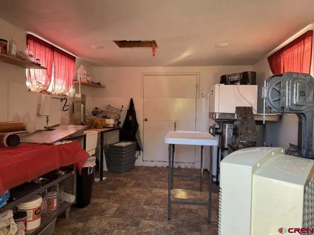 a view of storage and utility room with racks on the wall