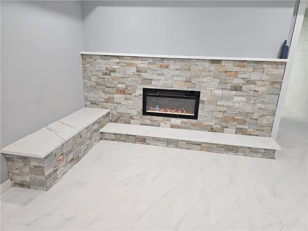 a kitchen with stainless steel appliances kitchen island granite countertop a refrigerator and a sink