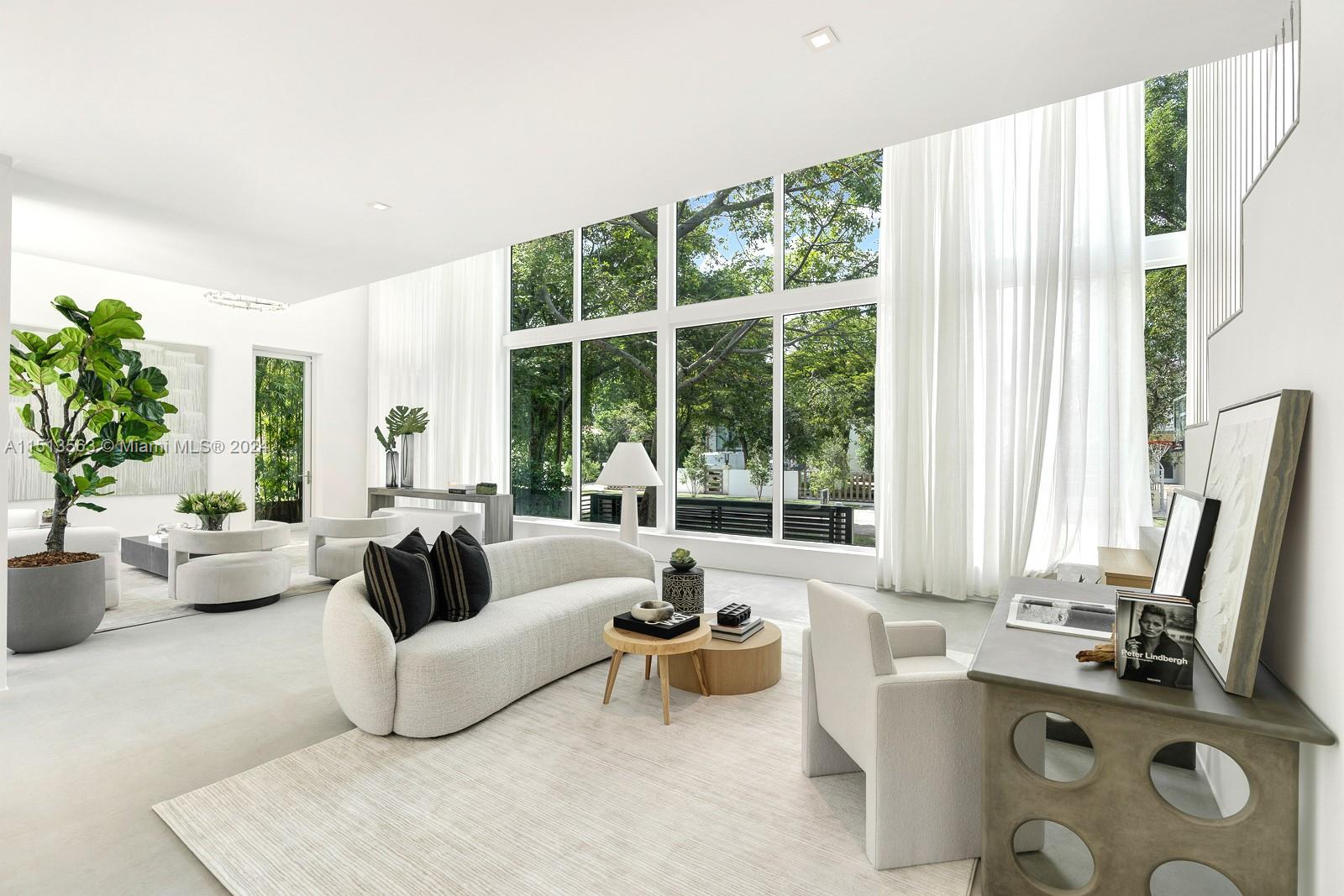 4433 North Bay Road Miami Beach, FL 33140 - Photo 1 of 1 a living room with furniture and a large window