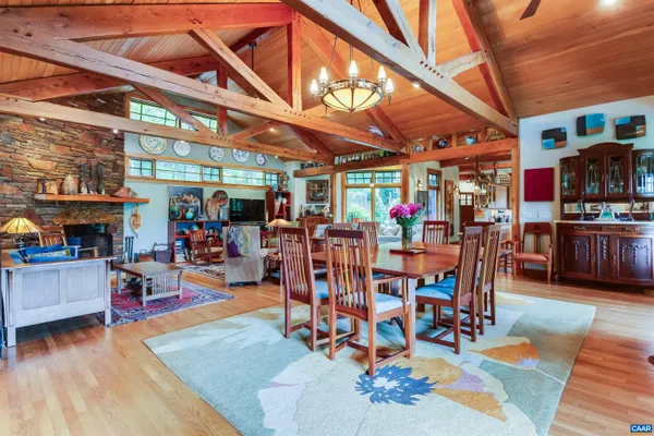 a view of a furniture in a room with window wooden floor and furniture