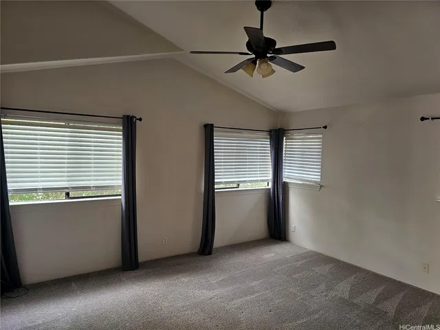 a view of a room with a window and a ceiling fan
