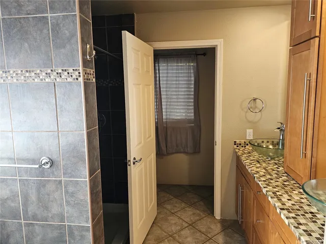 a bathroom with a walk in closet and wooden floor