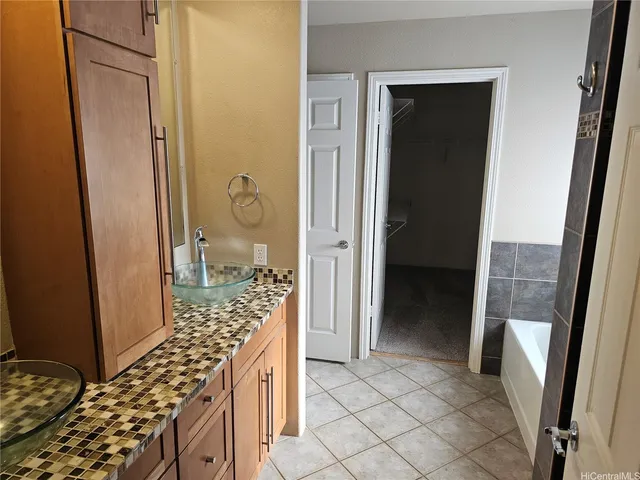 a bathroom with a granite countertop shower and a sink