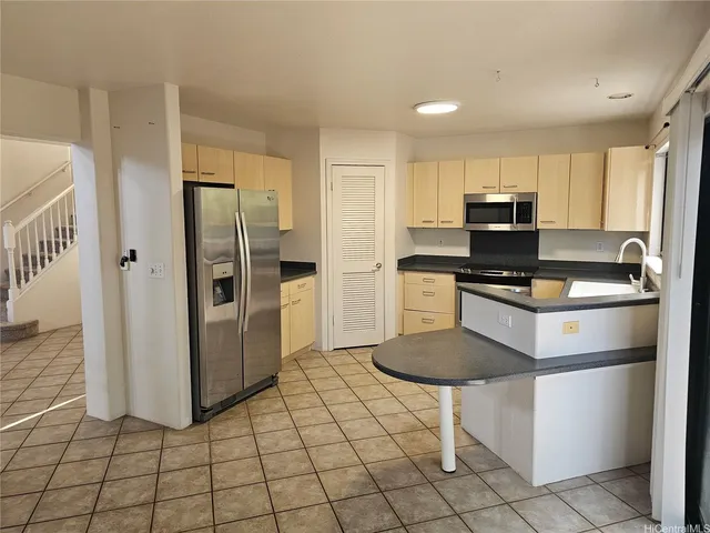 a kitchen with a refrigerator a stove a sink and a refrigerator