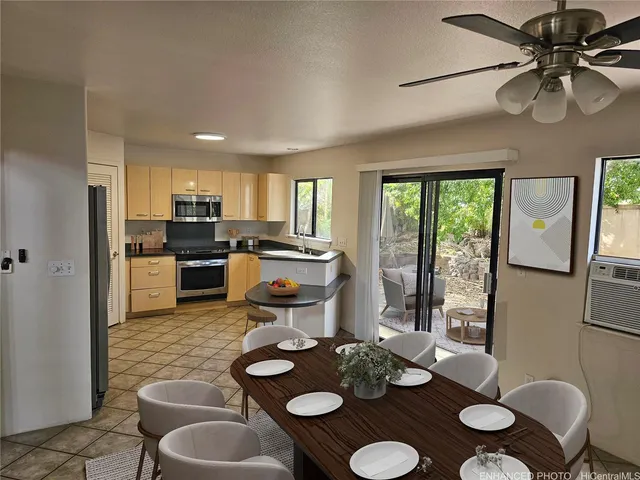 a kitchen with furniture appliances and a table