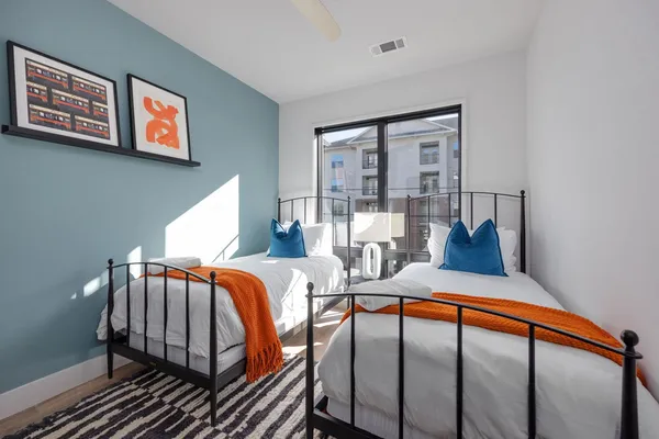 a bedroom with furniture and a large window
