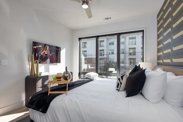 a bedroom with a bed and glass window