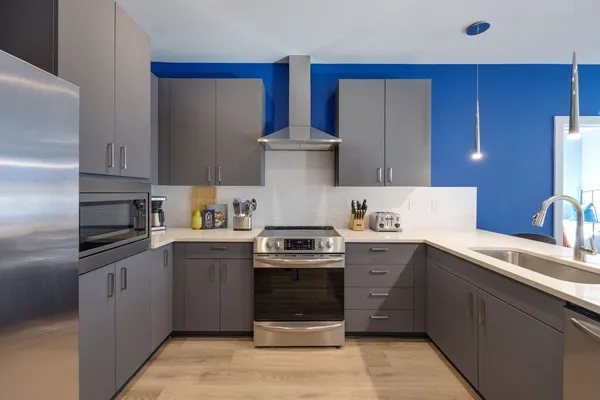 a kitchen with a stove top oven and cabinets