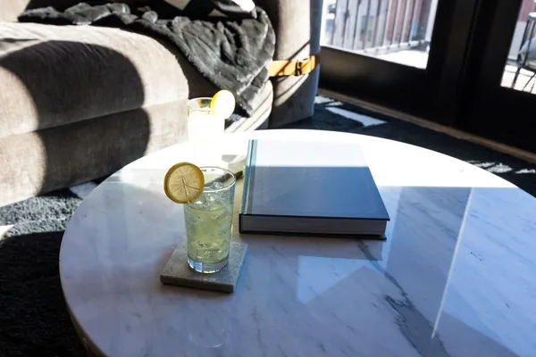 a bed sitting in a bedroom next to a window with wooden floor