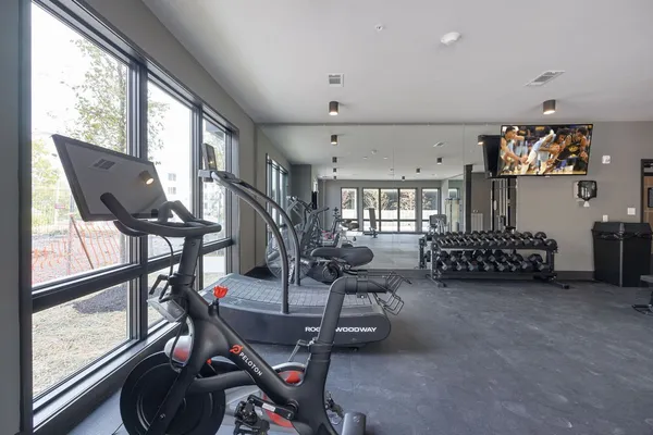 a room with gym equipment and a large window