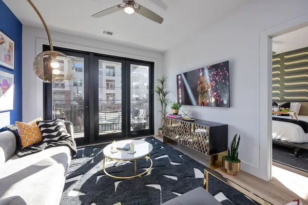 a living room with furniture and a floor to ceiling window