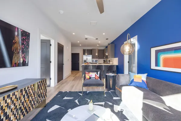 a living room with furniture and kitchen view