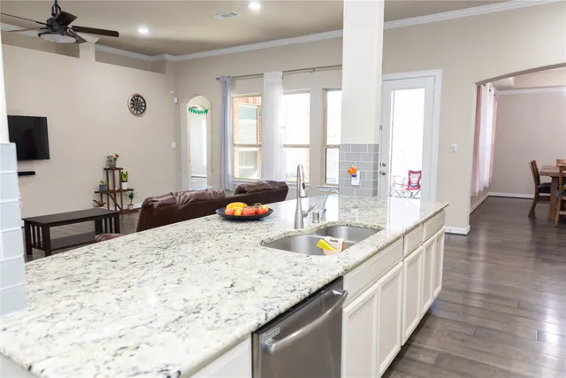 a kitchen with stainless steel appliances granite countertop a stove a sink and a microwave