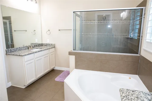 a bathroom with a bathtub and a sink