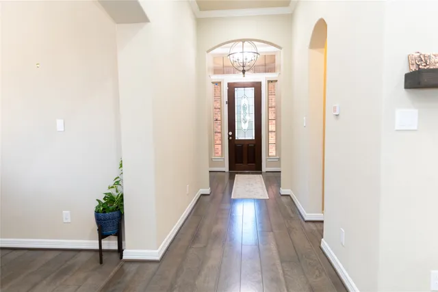 a living room with furniture wooden floor and a view of kitchen