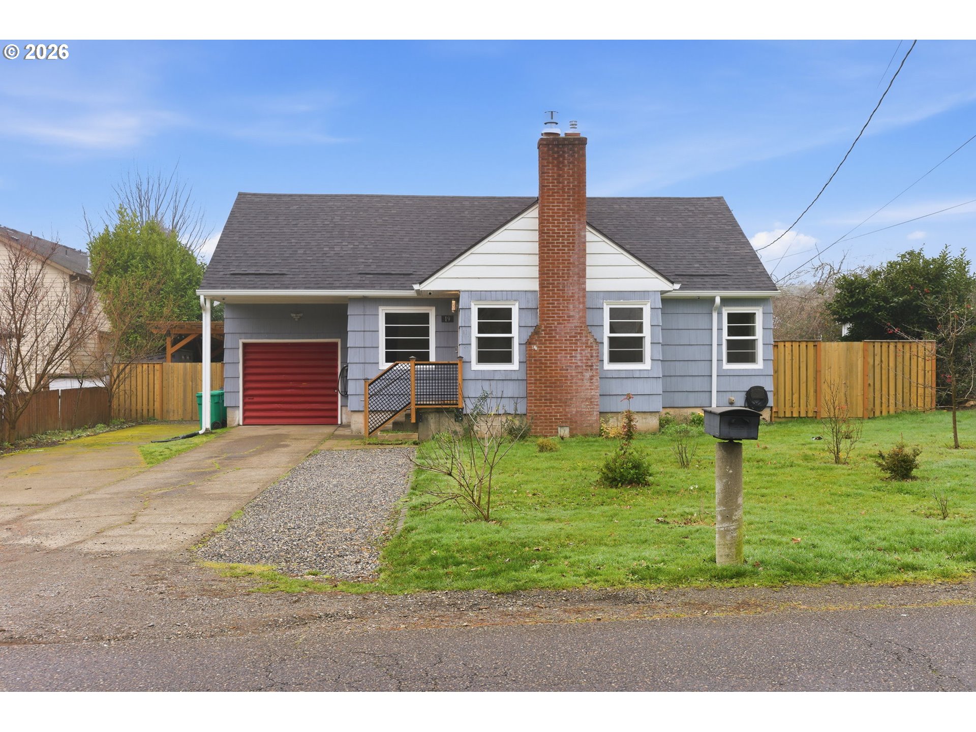 19 Northeast 139th Avenue Portland, OR 97230 - Photo 48 of 48 a front view of a house with a yard and garage