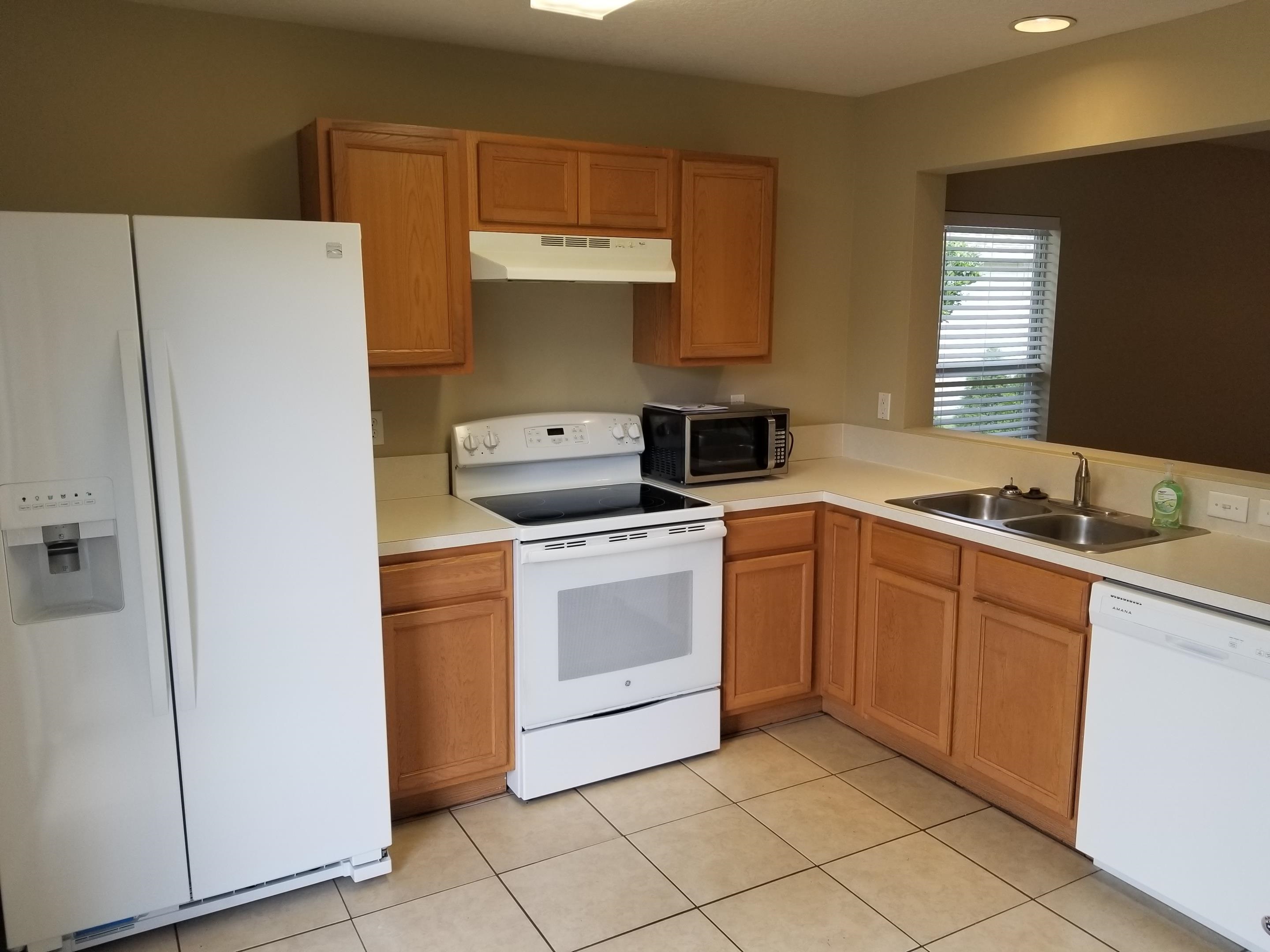 137 Buck Run Way St. Augustine, FL 32092 - Photo 2 of 21 a kitchen with stainless steel appliances a stove a sink and a refrigerator