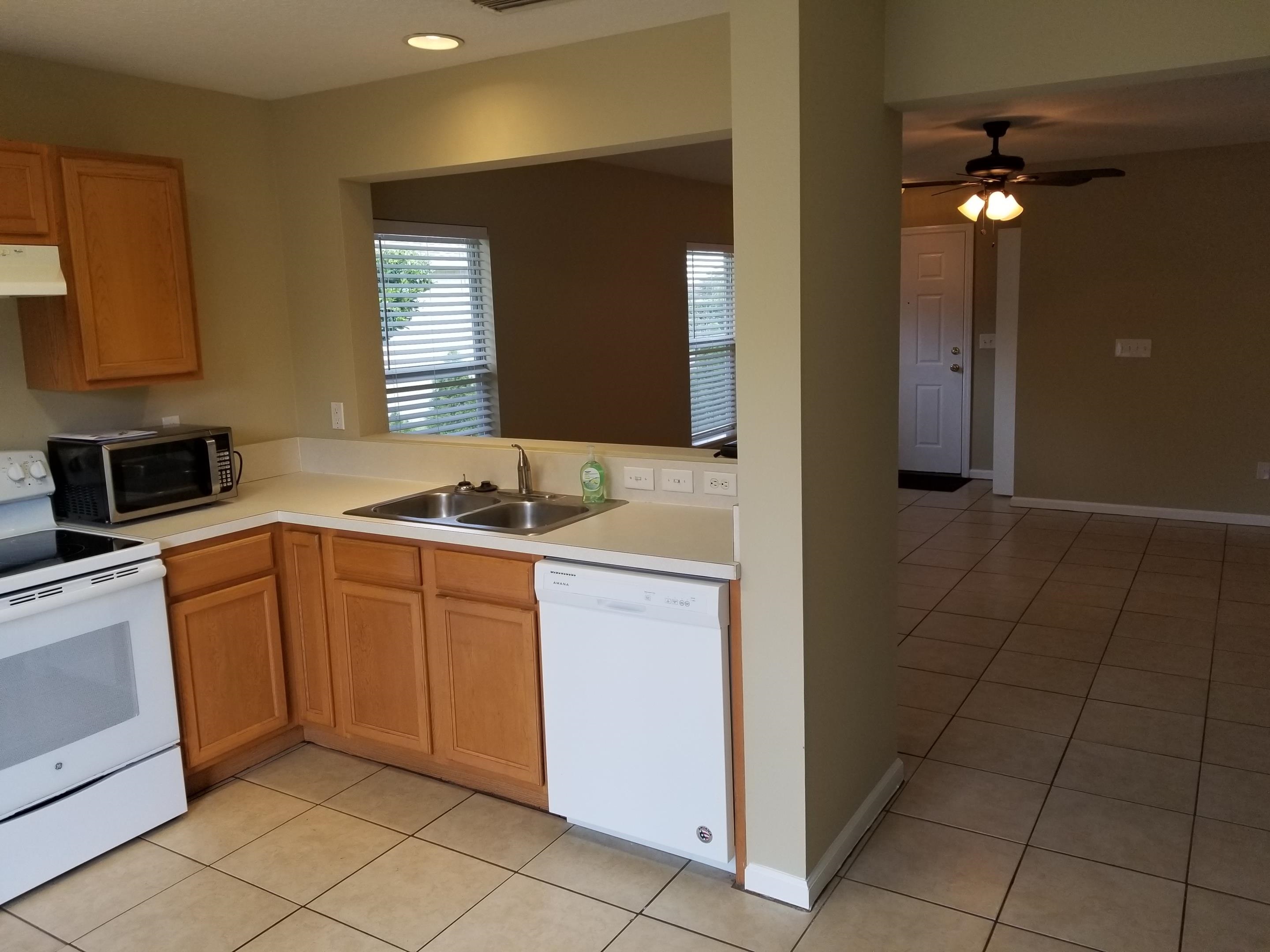 137 Buck Run Way St. Augustine, FL 32092 - Photo 3 of 21 a kitchen with stainless steel appliances granite countertop a sink and cabinets