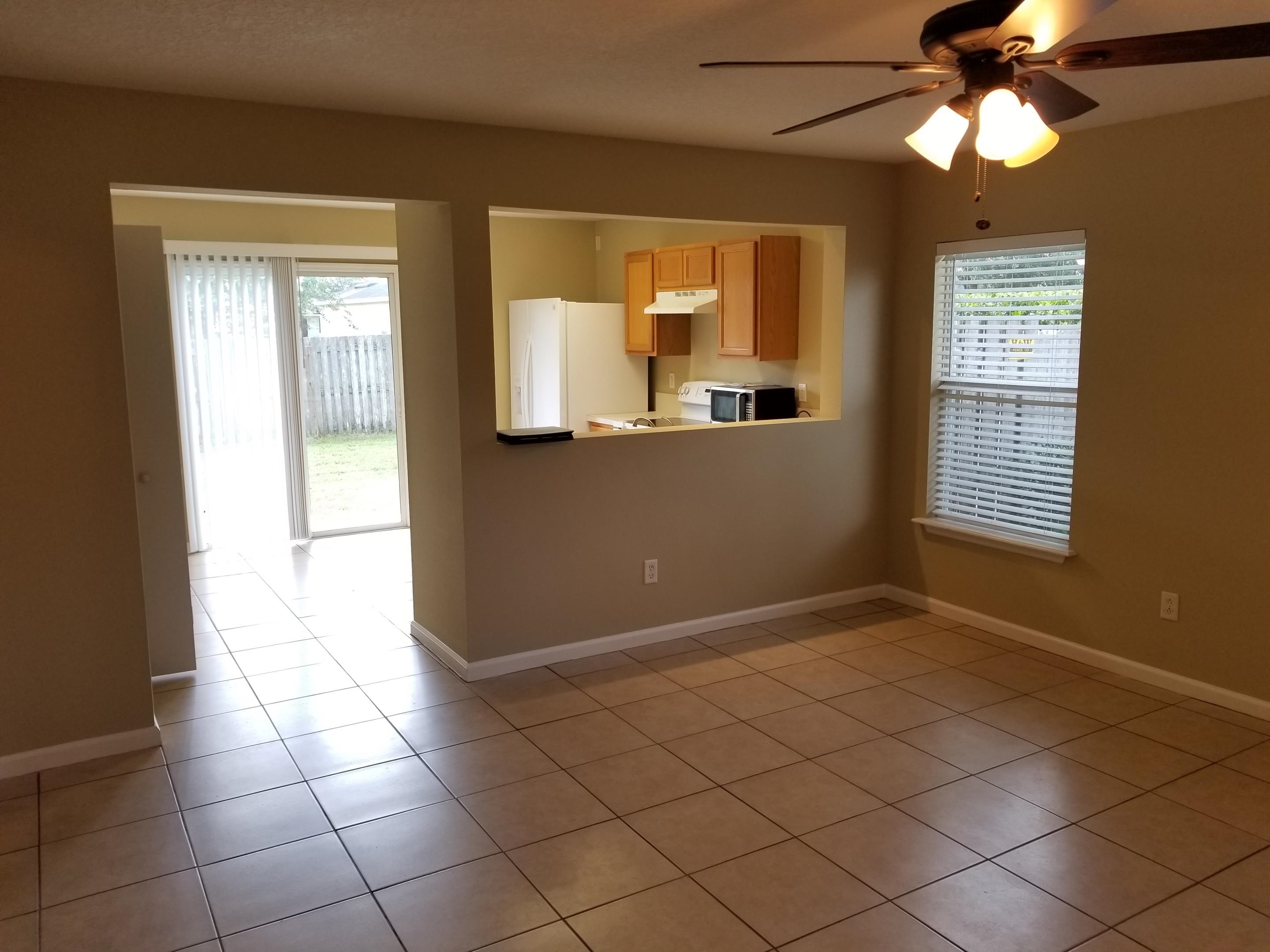 137 Buck Run Way St. Augustine, FL 32092 - Photo 4 of 21 a view of an empty room with window and chandelier fan