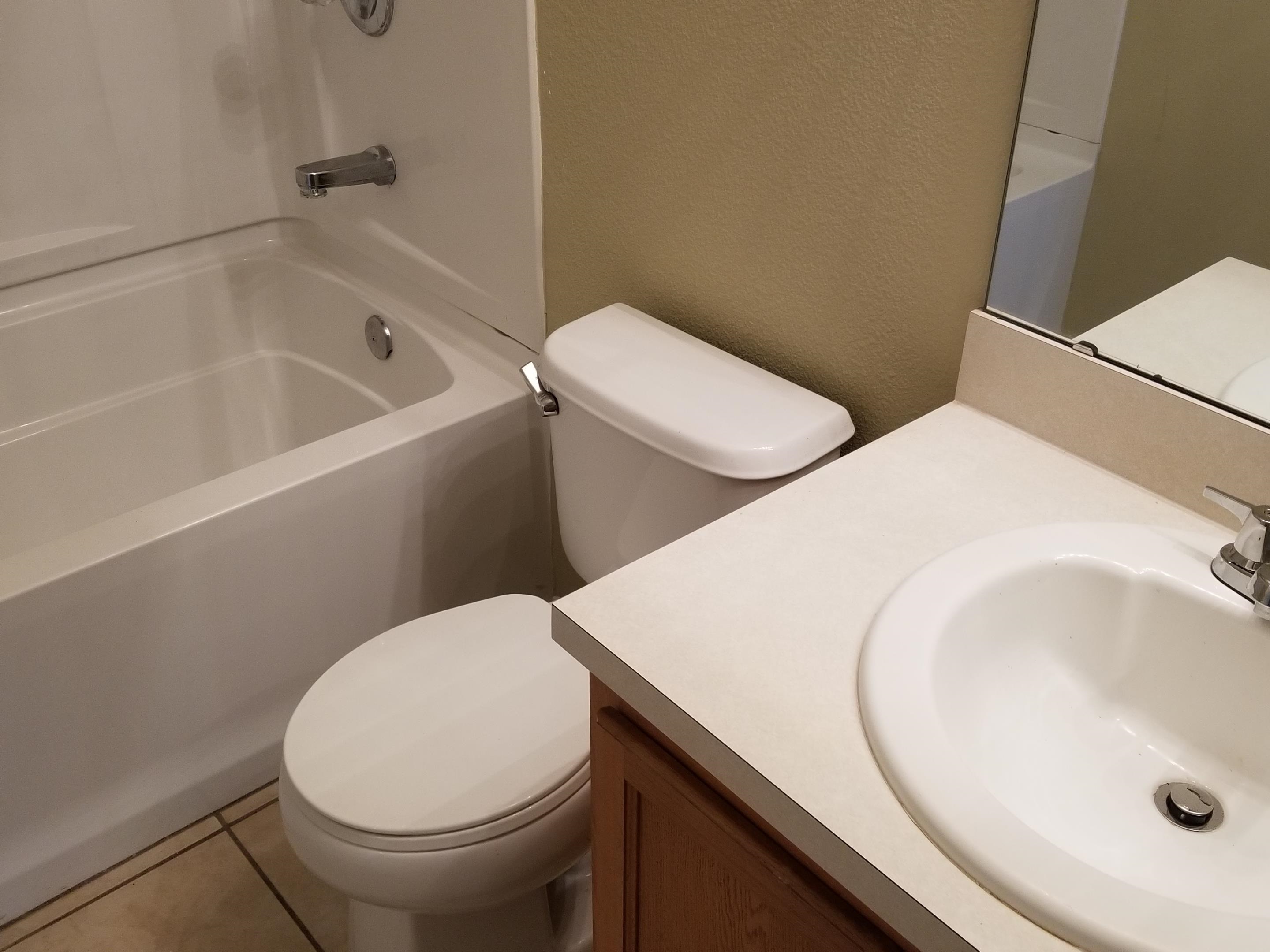 137 Buck Run Way St. Augustine, FL 32092 - Photo 8 of 21 a white toilet sitting next to a bathroom sink and tub