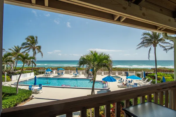 a view of a balcony with wooden floor and outdoor space